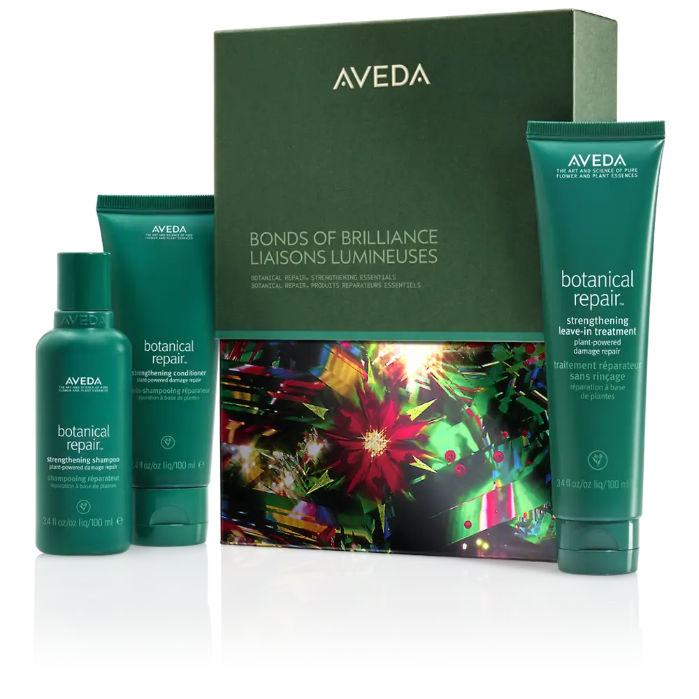 Aveda Bonds of Brilliance set with three green bottles of Botanical Repair hair care products displayed in front of a decorative box, available at Salon Dulay in Orlando, FL. - Salon Dulay, FL